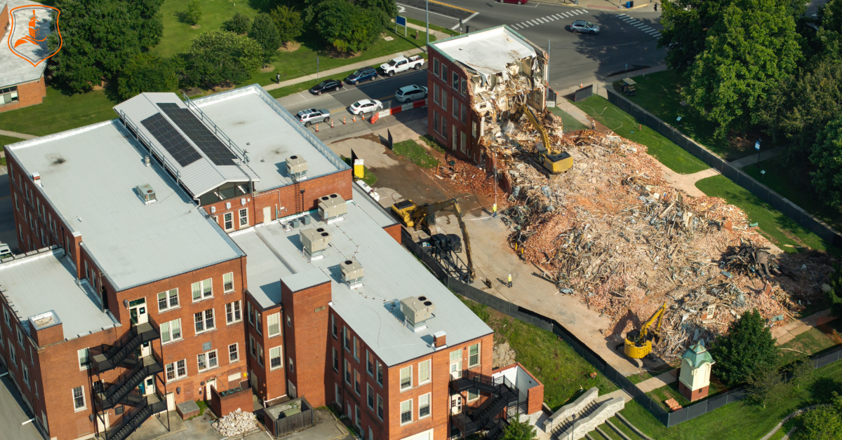 Aerial view of demolition and excavation equipment clearing a building site in Dallas–Fort Worth, Texas — representing Eastman Insurance Solutions’ insurance for demolition and excavation contractors.