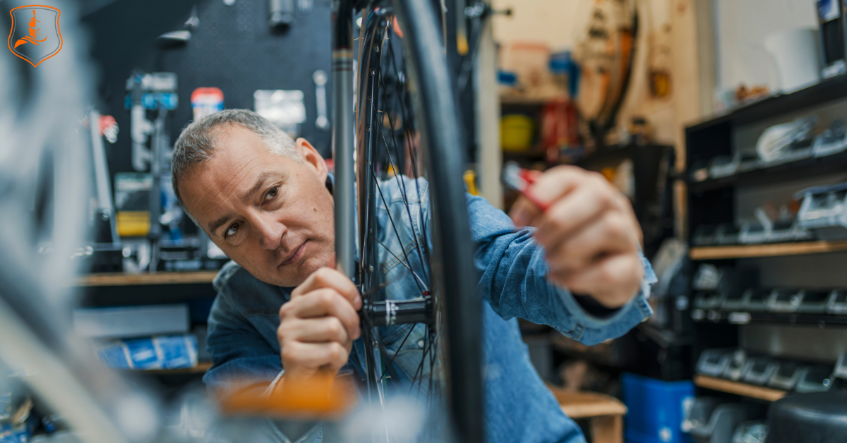 "Small business owner repairing a bicycle wheel in a Texas workshop — representing hands-on local businesses protected by quick general liability insurance.
