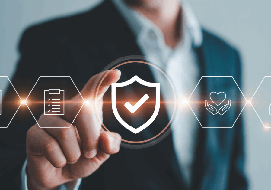 A business professional in a suit touches a digital shield icon representing protection, safety, and compliance — symbolizing EIS Texas’s proactive risk management leadership.