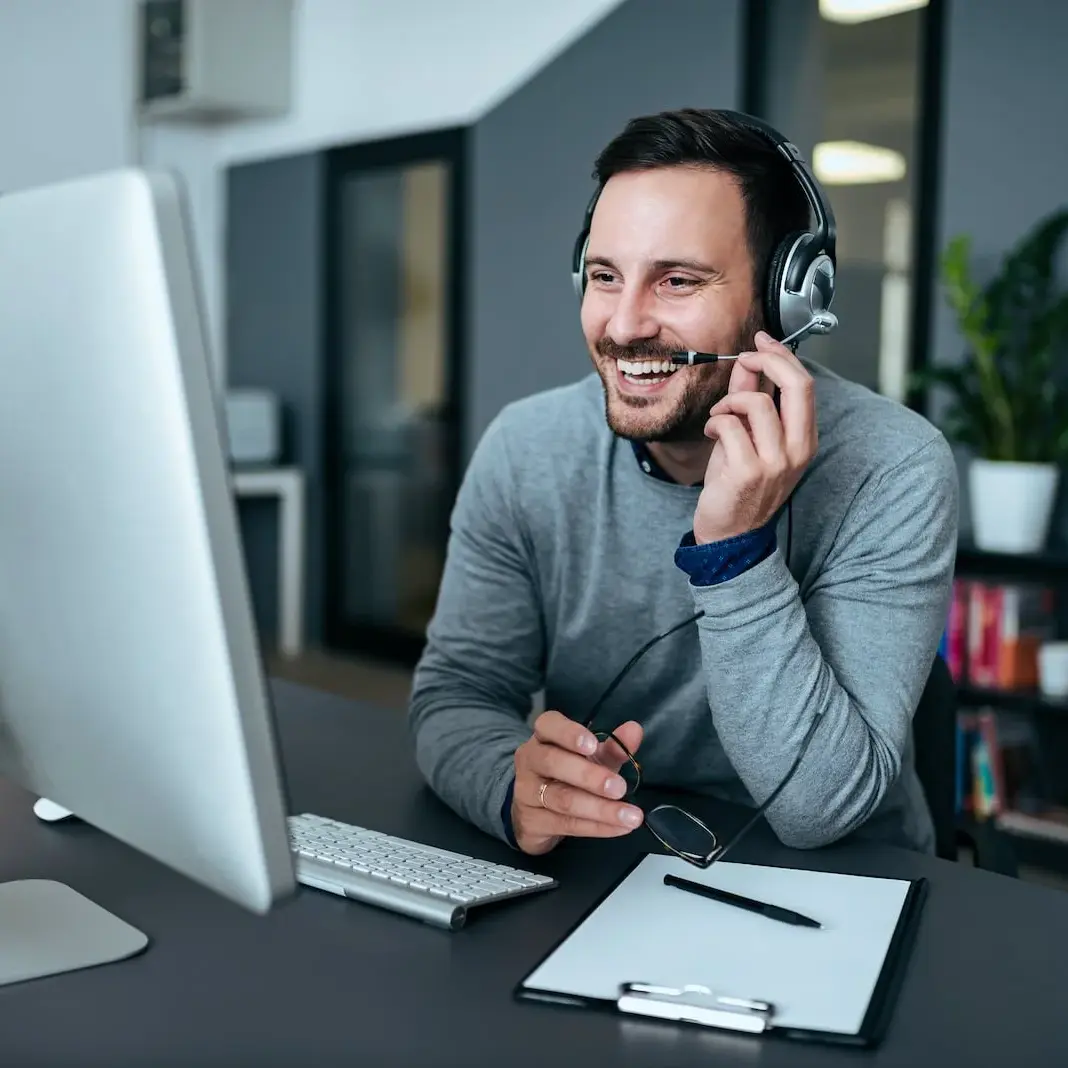 customer server representative smiling at desk